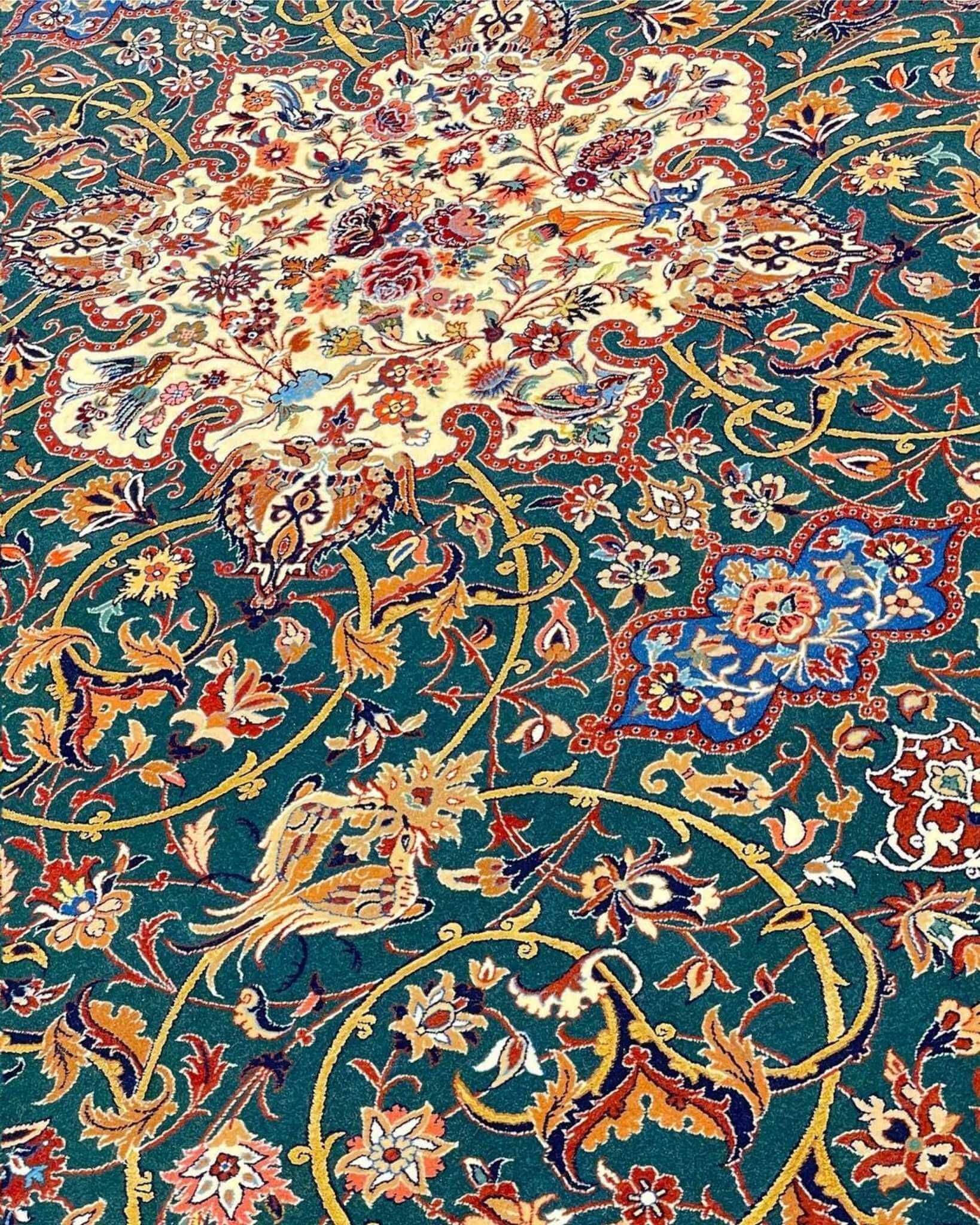 Handmade emerald green Seirafian rug with intricate floral and vine patterns.